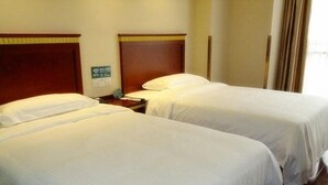 Two single beds with wooden headboards, a nightstand with a lamp, and a sign indicating Wi-Fi availability. - Greentree Inn Jiangsu Wuxi New District Shengang World Express Hotel (Wuxi)