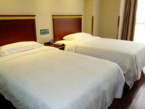 Two single beds with wooden headboards, a nightstand with a lamp, and a sign indicating Wi-Fi availability. - Greentree Inn Jiangsu Wuxi New District Shengang World Express Hotel (Wuxi)