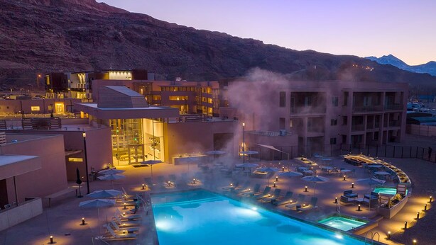 A resort with a pool, lounge chairs, and a mountainous backdrop. - Worldmark Moab 2 Bedroom Condo (Moab)