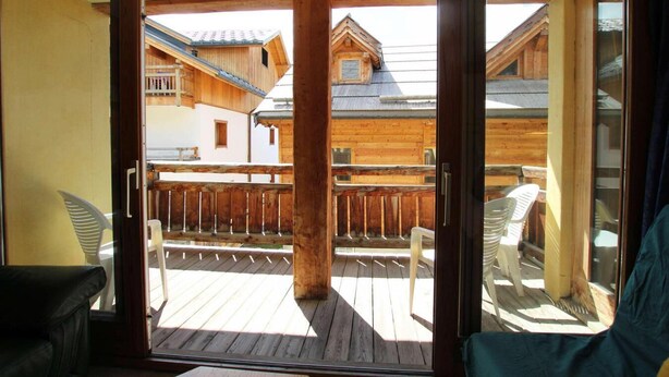 A wooden balcony with a view of a chalet-style building. - 100m from ski slopes, 1st floor, balcony, parking, tv, 54m², Montgenèvre (Montgenèvre)