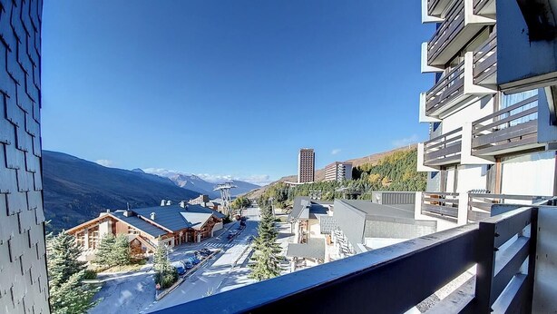 A modern hotel with a balcony overlooking a mountainous landscape. - 50m from ski slopes, 2nd floor, balcony, tv, 38m², Les Menuires (Les Menuires)