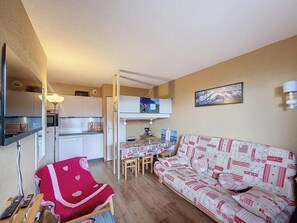 Cozy living space with a kitchenette, dining table, and comfortable seating area.