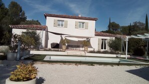 A two-story house with a tiled roof, a patio with outdoor furniture, and a swimming pool. - Villa Pampérigouste - air conditioning and swimming pool (SOLLIES TOUCAS)