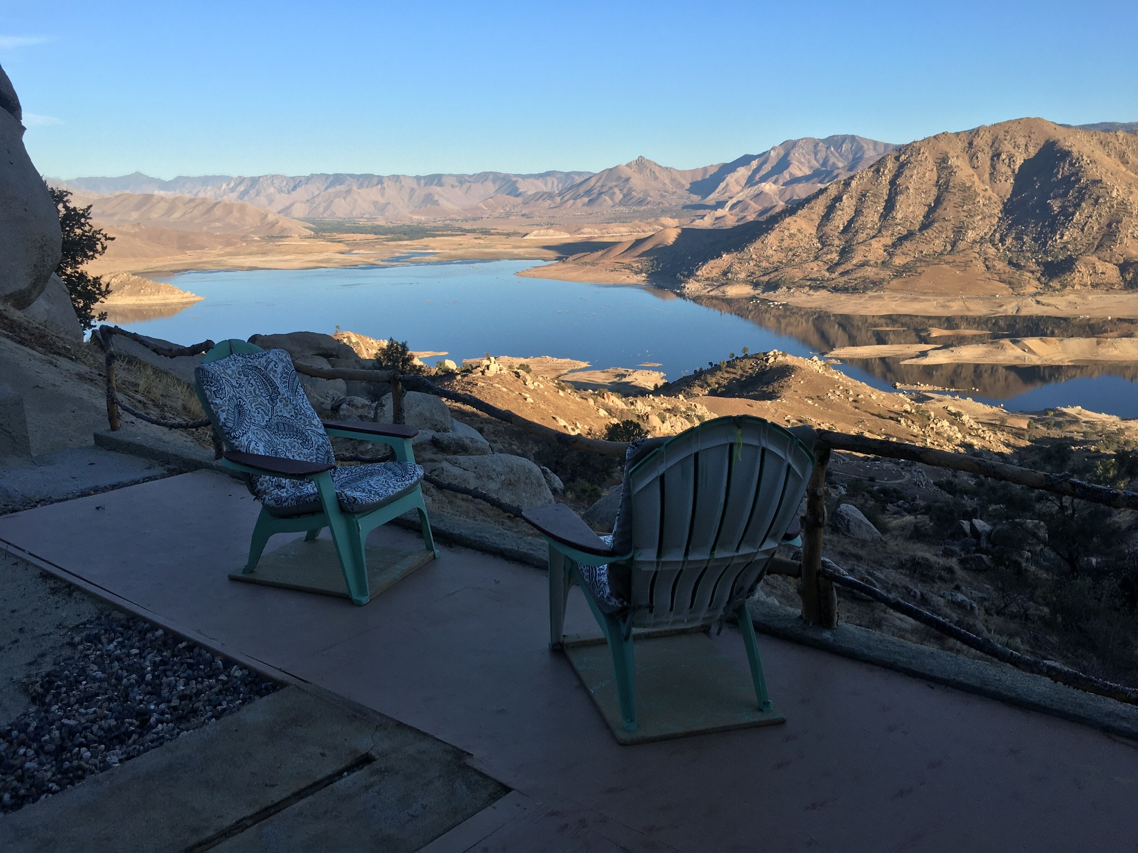  High on a mountainside with a hot tub on a deck.