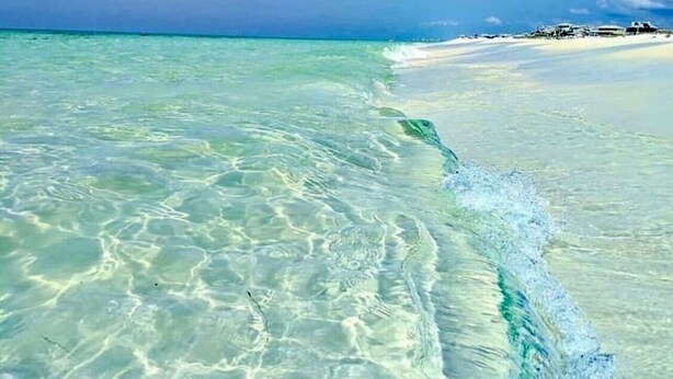 A beach with clear shallow waters leading to a sandy shore. - Boho Beach Vibes @ Caribbean Dunes,125 (Destin)