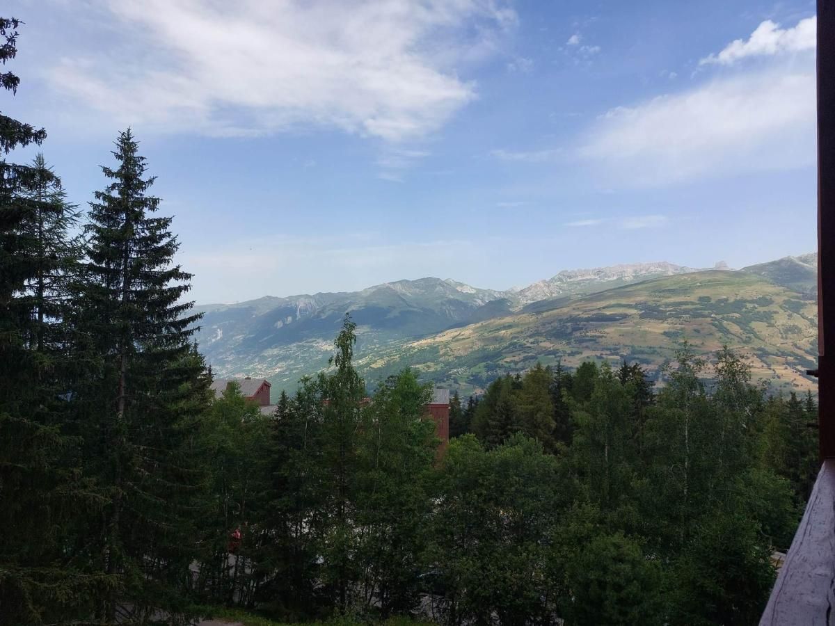 A mountainous landscape with a view of distant hills and a clear sky.
