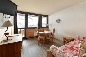 Relax in this inviting room with a comfortable bed, round table, and window view.