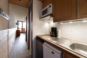 Enjoy cooking in this well-equipped kitchen with a stainless steel sink, microwave, and coffee maker.
