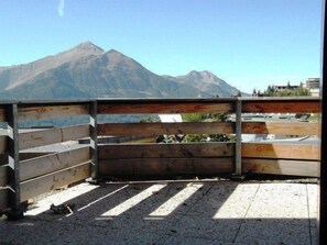 A balcony with a view of a mountain.