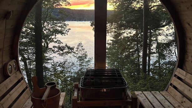 A circular wooden structure with a bench and a grill, overlooking a lake and forest. - The Sauna Cottage on Keuka Lake - Wine Trail Retreat (Keuka Park)