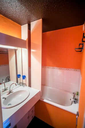 A bathroom with a white sink, mirror, and bathtub. - 200m from resort center, 6th floor, balcony, tv, 28m², Vars (Vars)
