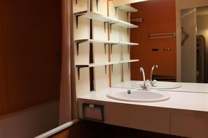 A modern bathroom with a white sink, a mirror, and built-in shelves. - 50m from resort center, 7th floor, view mountain, balcony, parking, tv, 28m², Vars (Vars)