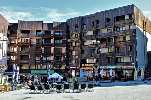Experience the contemporary style of this multi-story building, featuring a mix of dark panels and glass windows.