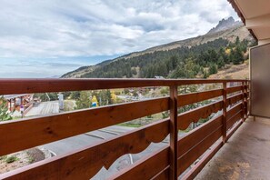 A balcony with a view of a mountainous landscape.