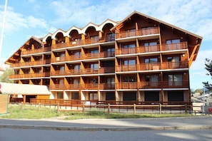 Ein mehrstöckiges Holzgebäude mit Balkonen, wahrscheinlich ein Hotel oder eine Unterkunftseinrichtung.