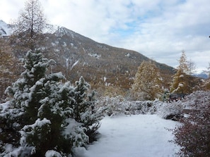 A snowy landscape with a mountain in the background.