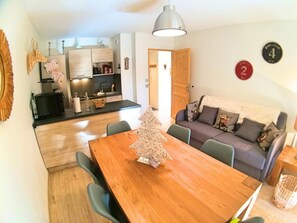 Cozy living space with a central dining table and comfortable seating area.