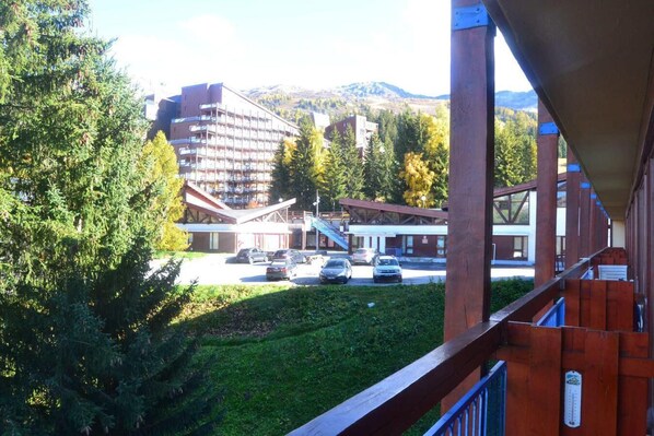 Situated in a lush, green area, this hotel features a modern architectural design with a multi-story building and balconies.