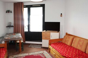 Cozy retreat with a single bed, desk, and TV, perfect for a relaxing stay.