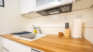 A modern kitchen with a wooden countertop, a sink, and a window above the sink. - Welcoming Studio Walk to Palisades Resort & Lifts (Olympic Valley)