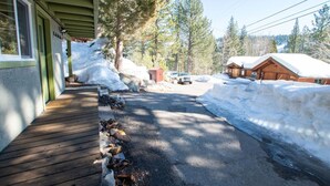 A cabin with a wooden deck and snow-covered surroundings. - Welcoming Studio Walk to Palisades Resort & Lifts (Olympic Valley)
