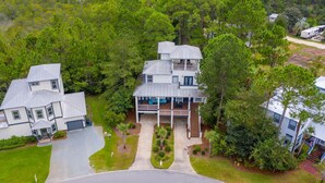 A multi-story house with a balcony, surrounded by dense greenery. - 2 min to the beach with 30A's largest pool, plus stunning decks, and 4 bikes (Santa Rosa Beach)