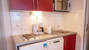 A compact kitchen with a microwave, coffee maker, toaster, and a dishwasher. - 130m from ski slopes, 1st floor, balcony, parking, tv, ski locker, 27m², La Norma (La Norma)