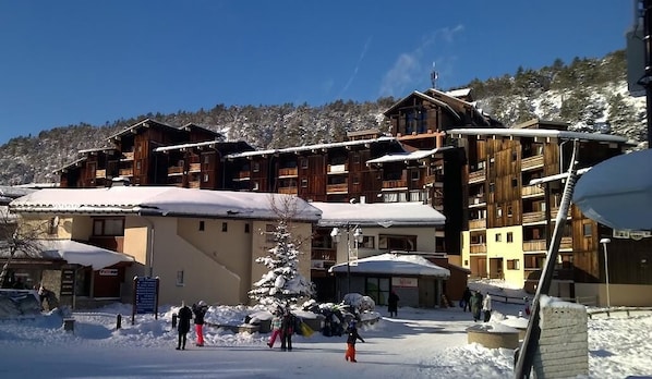 Guest accommodations offer stunning views of the surrounding snowy landscape from large windows and balconies.