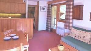 A compact living space with a dining area, a sofa, and a kitchen. - 30m from ski slopes, 3rd floor, view mountain, balcony, tv, ski locker, 58m², Méribel (Méribel - Les Allues)