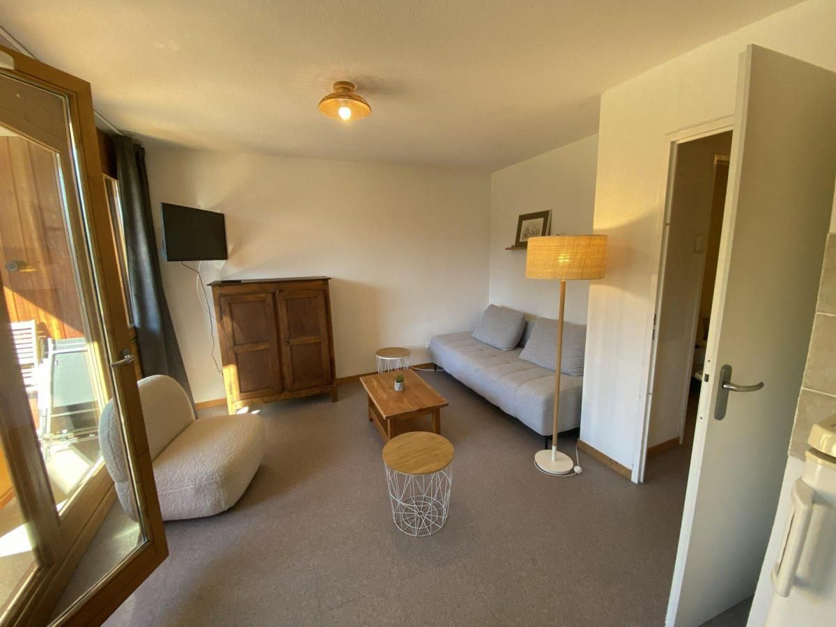 A living room with a sofa, a coffee table, a lamp, and a cabinet.
