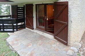 Relax in a serene outdoor space with a stone-paved patio and lush surroundings.