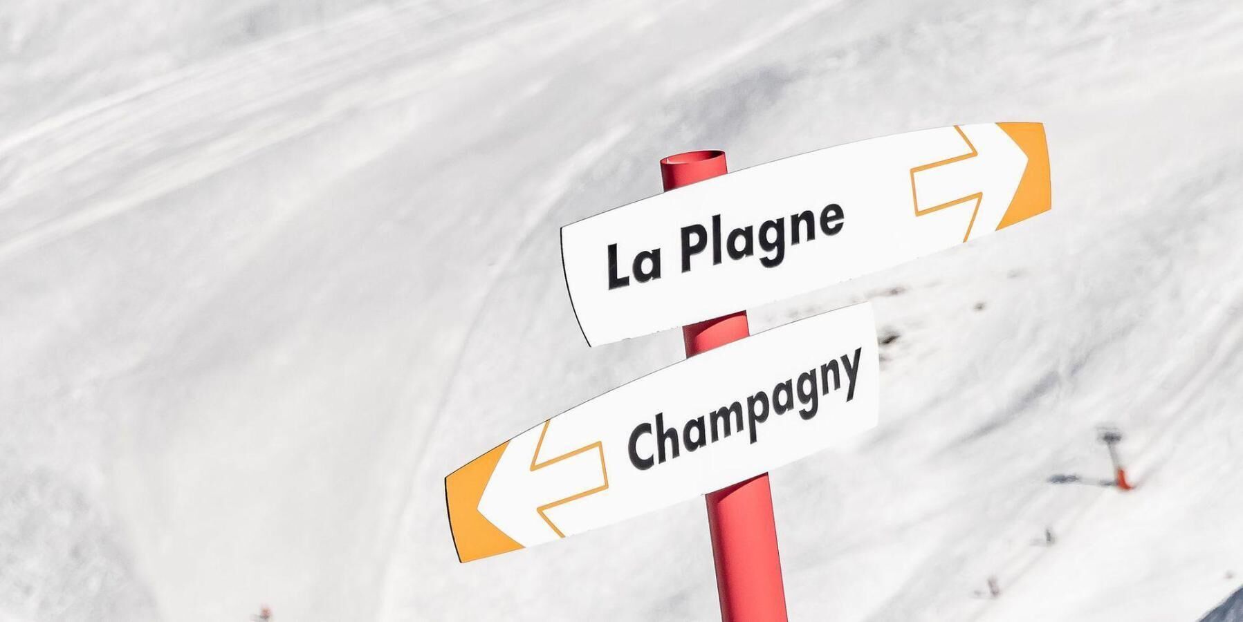 A signpost with directions to La Plagne and Champagne.