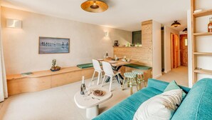 A modern kitchen with a dining area, wooden cabinetry, and a built-in bench. - 200m from ski slopes, 3rd floor, balcony, fireplace or stove, tv, ski locker, 54m² (Champagny-en-Vanoise)
