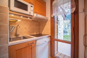 Enjoy cooking in this well-equipped kitchen with microwave, sink, and dishwasher.