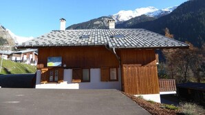 A wooden chalet with a sloped roof, a small porch, and a sign indicating it is a mountain guesthouse. - 200m from resort center, Ground floor, terrace, tv, ski locker, 72m², Champagny-en-Vanoise (Champagny-en-Vanoise)