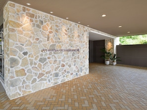 A stone wall with a sign reading "Atagawa Ocean Resort". - Atagawa Ocean Resort (Higashiizu)