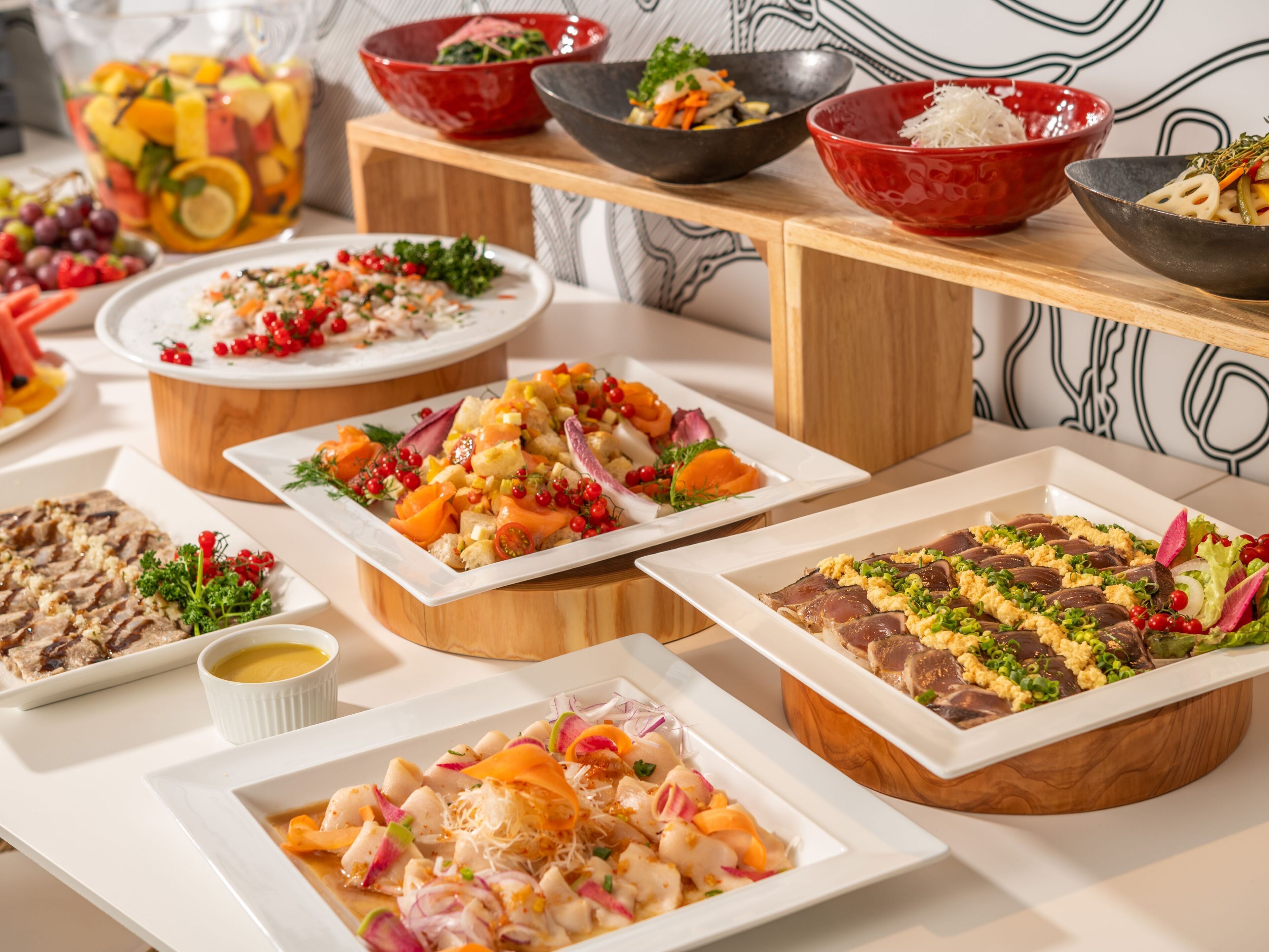 A buffet with various dishes including seafood, salads, and other appetizers.