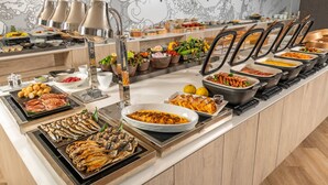 A buffet with various dishes, including seafood and salads, in a modern kitchen setting. - Atagawa Ocean Resort (Higashiizu)