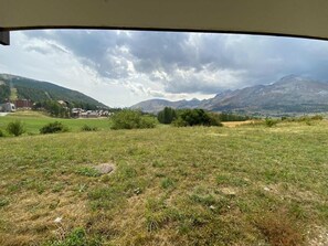 A grassy field with mountains in the background.