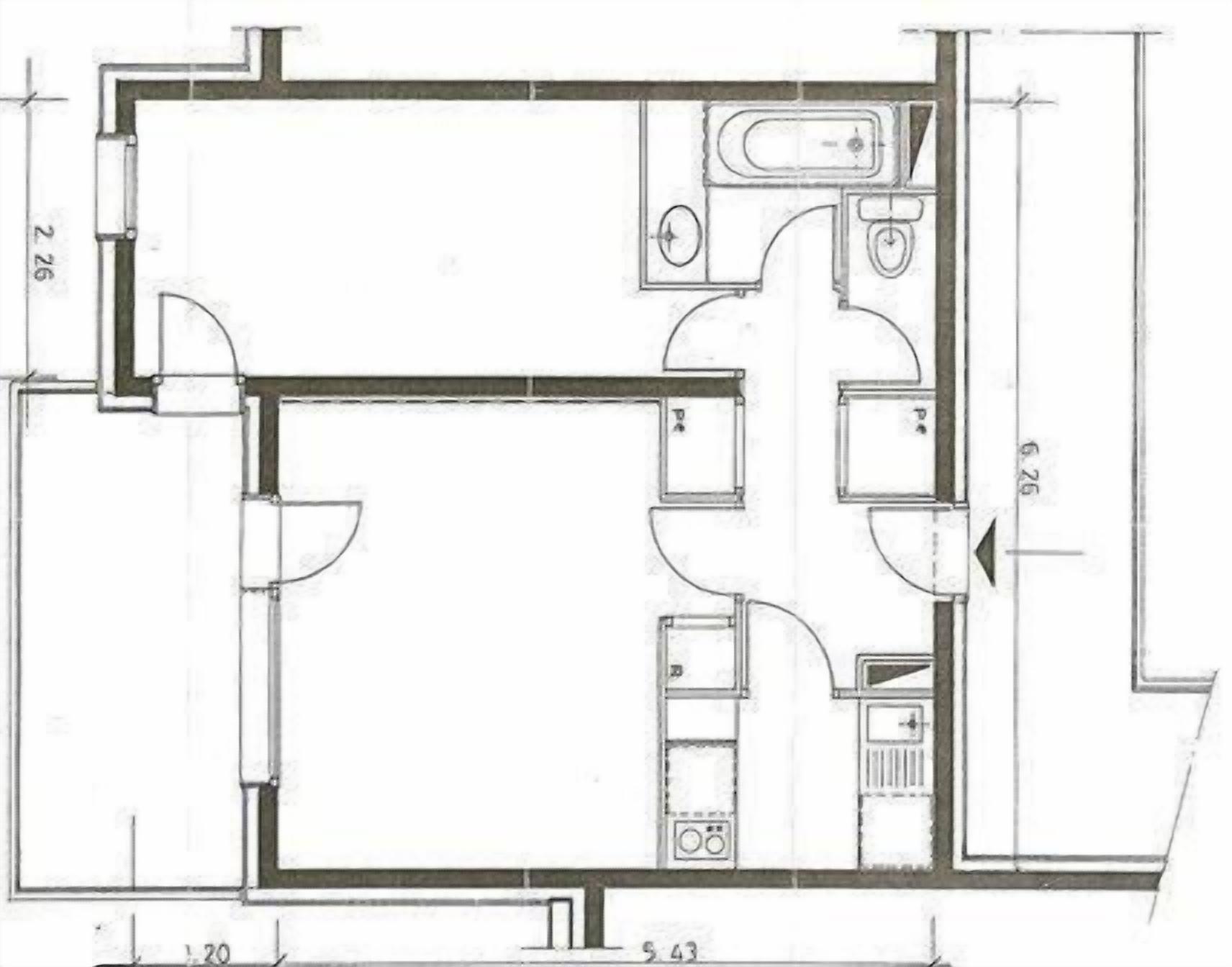 A floor plan of a hotel room with a bathroom, kitchenette, and a seating area.