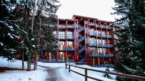 A multi-story building with balconies and a central staircase.