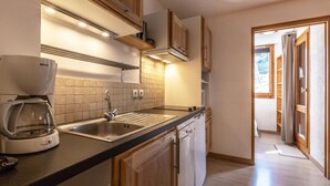 A modern kitchen with a Bosch coffee maker, a sink, and a dishwasher.