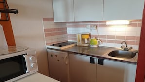 A compact kitchen with a microwave, coffee maker, and sink. - Wifi, 100m from ski slopes, 2nd floor, balcony, tv, ski locker, 27m², La Rosière (La Rosière Montvalezan)