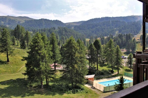 A pool area with a view of a mountainous landscape.