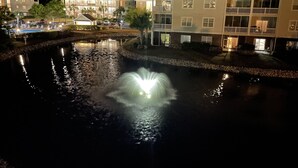 A nighttime view of a hotel with a pond and a fountain. - Inviting and Relaxing Beach and Golf Condo (North Myrtle Beach)