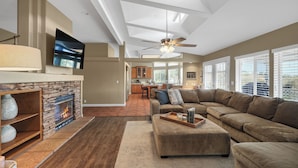 A spacious living room with a stone fireplace, a large sectional sofa, and a ceiling fan. - 2 Patios, BBQ, Center Wine Country (Temecula)