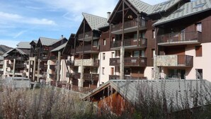 A row of multi-story buildings with balconies, likely part of a hotel or resort.