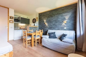 A compact living space with a kitchenette, a dining area, and a sofa. - 8th floor, view valley, balcony, ski locker, 22m², Valmorel (Valmorel)