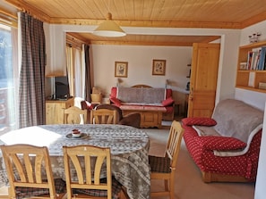 A cozy room with a dining table, chairs, a sofa, and a television. - 130m from shops, 4th floor, balcony, 53m², Méribel-Mottaret (Méribel - Les Allues)