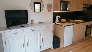 A compact kitchen with white cabinetry, a microwave, a sink, and a small refrigerator. - 1st floor, balcony, tv, 26m², Le Grand Bornand (Le Grand-Bornand)